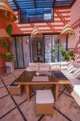 a living room with a couch and a table at Golf el maaden Splendide villa in Marrakech