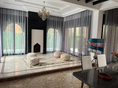 a large living room with a large bed with pillows at VILLA aVEC PISCINE CHAUFFÉE in Marrakech