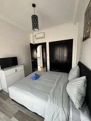 a bedroom with a bed with a blue bag on it at VILLA aVEC PISCINE CHAUFFÉE in Marrakech