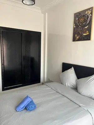 a bed with a blue item sitting on top of it at VILLA aVEC PISCINE CHAUFFÉE in Marrakech