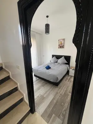 a bedroom with a bed and a large mirror at VILLA aVEC PISCINE CHAUFFÉE in Marrakech