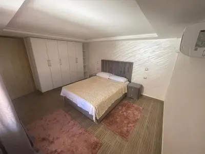 a small bedroom with a bed and white cabinets at Cosy appartement downtown gueliz in Marrakech