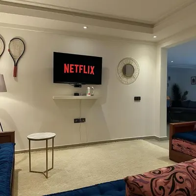 a living room with a netflix sign on the wall at Studio chic in Marrakech