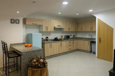 a kitchen with wooden cabinets and a counter with oranges on it at Studio chic in Marrakech