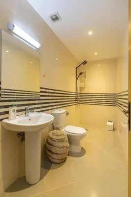 a bathroom with a sink and a toilet and a mirror at Studio chic in Marrakech