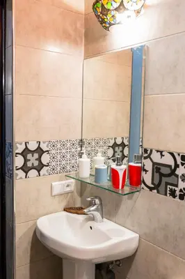 a bathroom with a sink and a mirror at Riad GALFANE in Marrakech