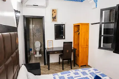a bedroom with a desk and a toilet in a room at Riad GALFANE in Marrakech