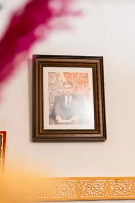 a picture of a man in a suit on a wall at Riad GALFANE in Marrakech
