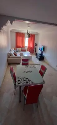 a living room with a table and chairs and a couch at Picasso - Appartement 1 chambre in Marrakech