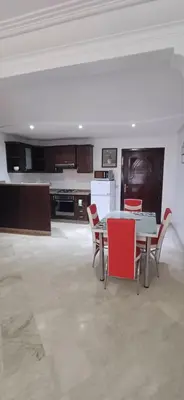 a kitchen with a table and chairs in a room at Picasso - Appartement 1 chambre in Marrakech
