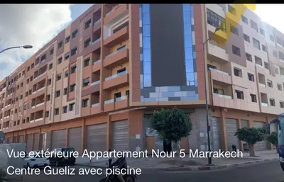 a building on a street with the words vive architecture apartmentament month mar at Appartement avec piscine en plein centre de Marrakech in Marrakech