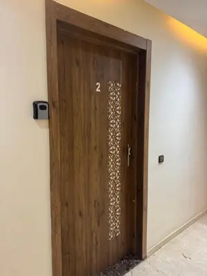 a wooden door with the number on it at Appartement avec piscine en plein centre de Marrakech in Marrakech