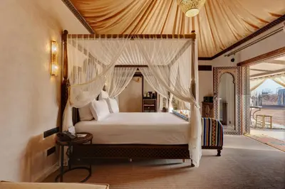 a bedroom with a bed with a canopy at Palmeraie Oasis Camp - A member of Barcelo Hotel Group in Marrakech