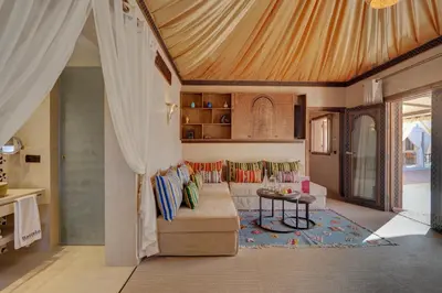 a living room with a couch and a table at Palmeraie Oasis Camp - A member of Barcelo Hotel Group in Marrakech