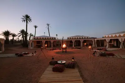 a group of tents in the desert at night at Palmeraie Oasis Camp - A member of Barcelo Hotel Group in Marrakech