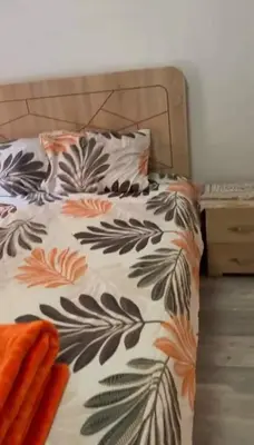 a bed with a black and white comforter with a pillow at 2-bedroom flat in Gueliz in Marrakech