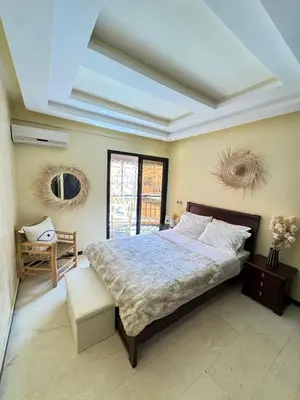 a bedroom with a large bed and a table at Bleu Majorelle, cœur de Gueliz in Marrakech