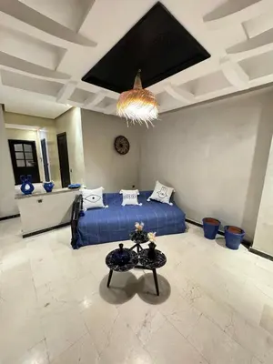 a bedroom with a bed and a table in it at Bleu Majorelle, cœur de Gueliz in Marrakech
