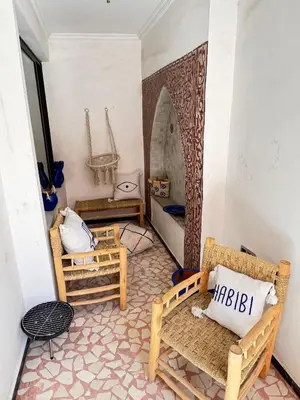 a room with chairs and a bed in a room at Bleu Majorelle, cœur de Gueliz in Marrakech
