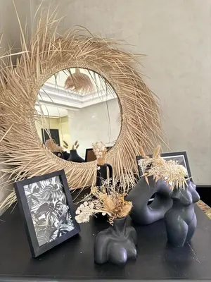 a table with two figurines and a round mirror at Bleu Majorelle, cœur de Gueliz in Marrakech