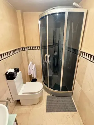 a bathroom with a toilet and a shower in it at Bleu Majorelle, cœur de Gueliz in Marrakech