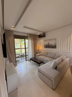 a living room with a couch and a table at Appartement cosy pour 4 personnes in Marrakech