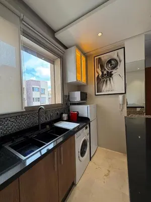a kitchen with a sink and a washing machine at Appartement cosy pour 4 personnes in Marrakech