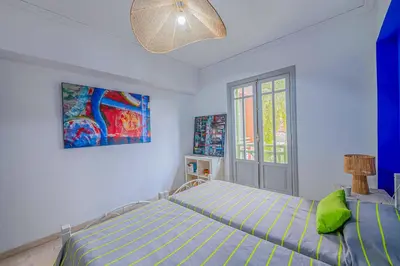 a bedroom with a bed and a painting on the wall at Luxury Apartment with Pool Large Terrace & Balconies in Hivernage Marrakech in Marrakech