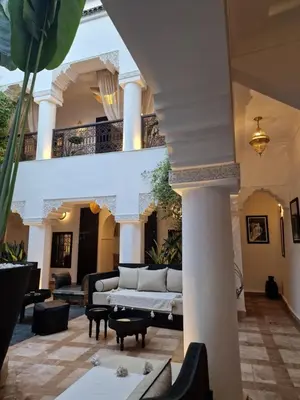 a living room with a couch and a table at Riad Dar El Mahja in Marrakech