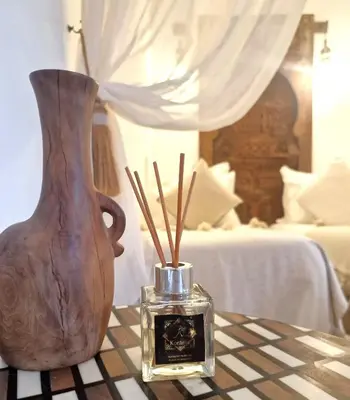 a vase and a box of sticks on a table at Riad Dar El Mahja in Marrakech