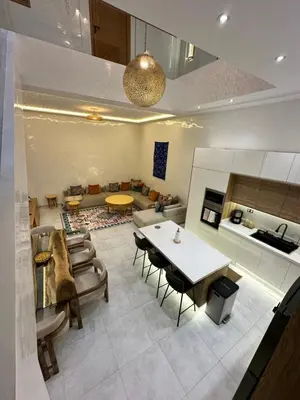 a kitchen and living room with a table and chairs at Riad De Luxe Marrakech in Marrakech