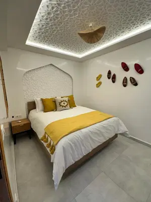 a bedroom with a bed and shoes on the wall at Riad De Luxe Marrakech in Marrakech