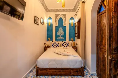 a bedroom with a bed in a room at Riad La Perle Bleue Marrakech in Marrakech