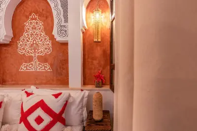 a room with a bed with red and white pillows at Riad La Perle Bleue Marrakech in Marrakech