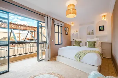 a bedroom with a bed and a large window at Riad Chama 10mn from Jamaa Al Fna in Marrakech