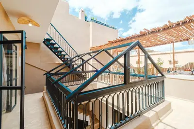a staircase in a house with a balcony at Riad Chama 10mn from Jamaa Al Fna in Marrakech