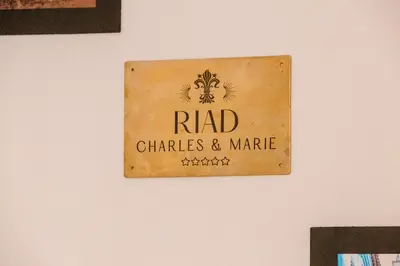 a sign on a wall that reads radi charities and market at Riad Chama 10mn from Jamaa Al Fna in Marrakech