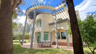 a house with an archway in a yard at Dar El Hana 4 Bedroom Villa in Marrakech