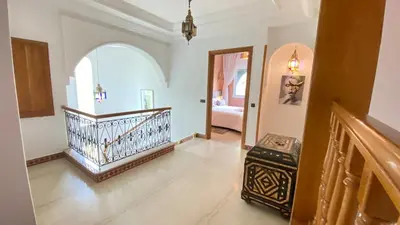 a living room with a staircase and an entry way at Dar El Hana 4 Bedroom Villa in Marrakech