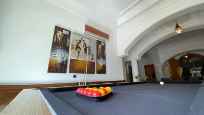 a ping pong table with balls on it in a room at Dar El Hana 4 Bedroom Villa in Marrakech