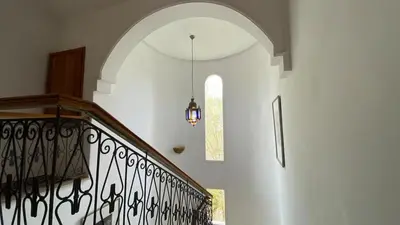 a hallway with a staircase with a pendant light at Dar El Hana 4 Bedroom Villa in Marrakech