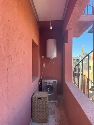 a laundry room with a washing machine in a wall at Cozy flat in Marrakesh in Marrakech
