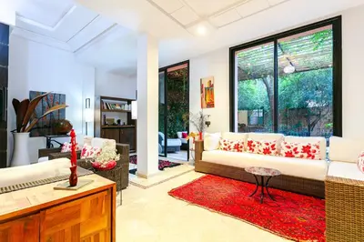 a living room with a couch and a red rug at Villa Atlas Dreams in Marrakech