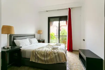 a bedroom with a bed and a red curtain at Villa Atlas Dreams in Marrakech