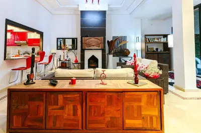 a kitchen with a wooden island in a living room at Villa Atlas Dreams in Marrakech