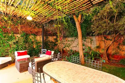 a table and chairs under a pergola on a patio at Villa Atlas Dreams in Marrakech