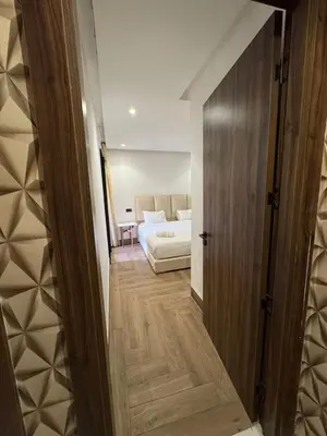 a hallway leading to a bedroom with a bed at Modern and Cozy Apartment Guéliz in Marrakech