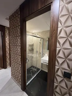 a bathroom with a glass shower and a sink at Modern and Cozy Apartment Guéliz in Marrakech