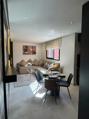 a living room with a couch and a table and chairs at Modern and Cozy Apartment Guéliz in Marrakech