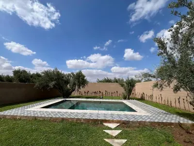 a swimming pool in the middle of a yard at Villa JADE with private pool only family in Marrakech